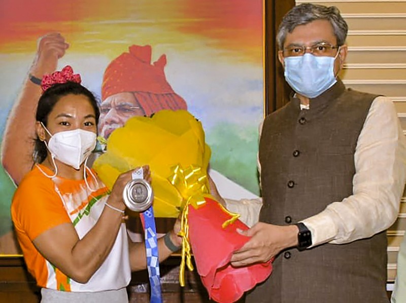 **EDS: IMAGE POSTED BY @RailMinIndia ON TUESDAY, JULY 27, 2021** New Delhi: Union Railway Minister Ashwini Vaishnaw felicitates Olympic silver medallist and Indian Railways' weightlifter Mirabai Chanu in New Delhi. (PTI Photo)